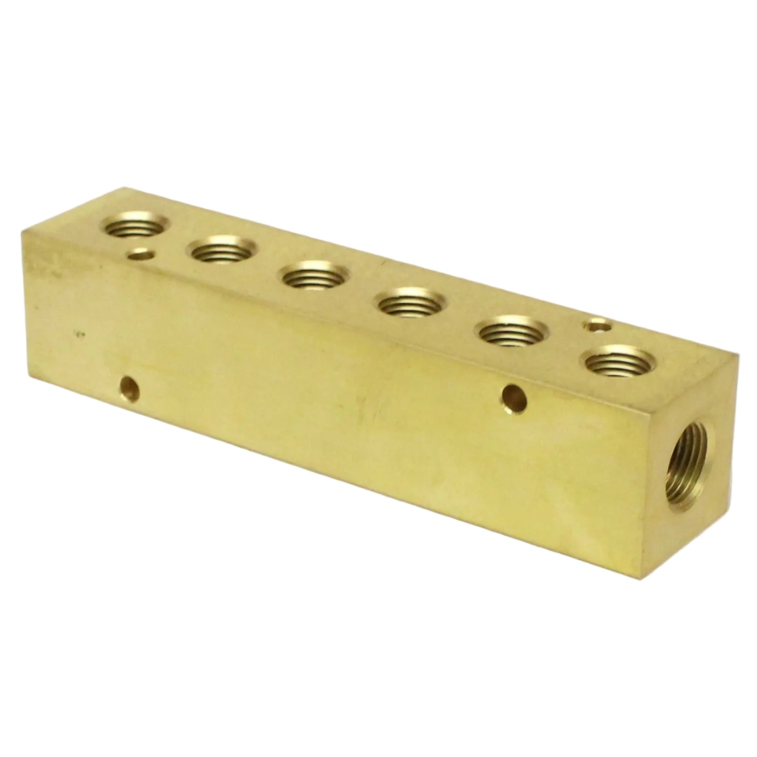 Brass block with multiple threaded holes on a beige background